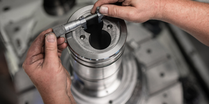 A rubicon employee checks the dimensional accuracy of a milled machine component.
